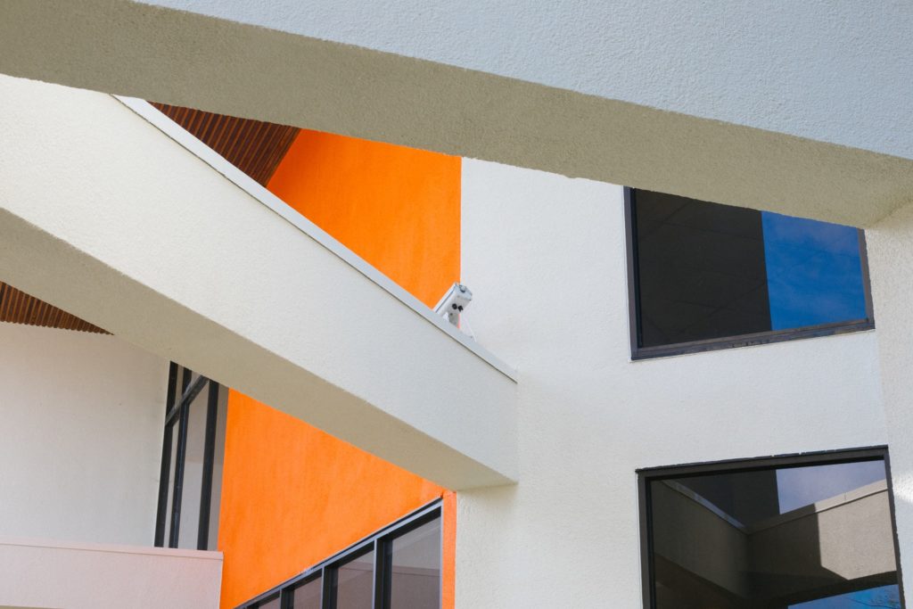 a white and orange building with a black and white window